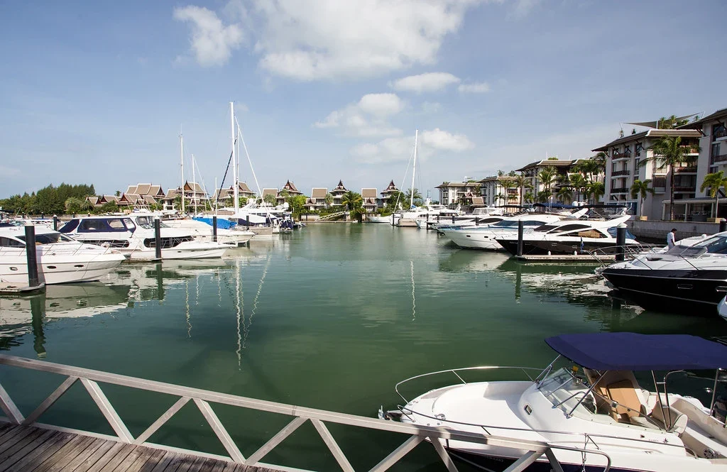 Марины Royal Phuket Marina в районе Ко Кеу на Пхукете, яхты у причалов среди тропической застройки