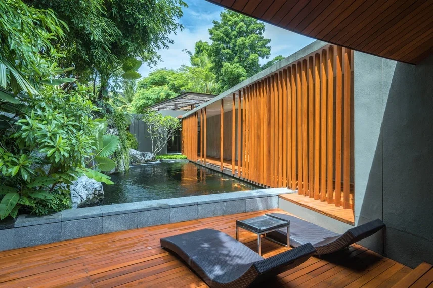 Два шезлонга на деревянной террасе у водоёма Quan Spa в Renaissance Phuket